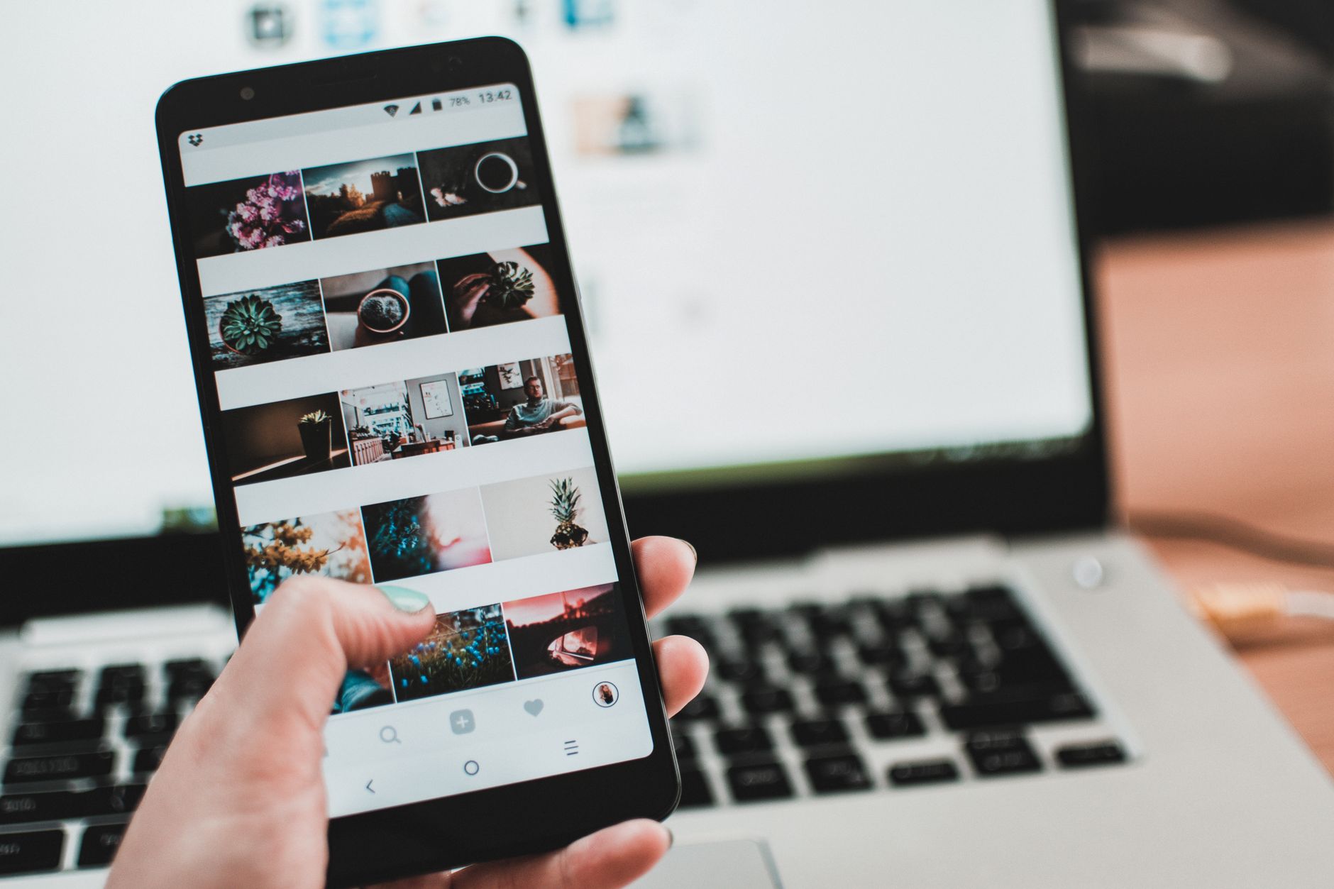 Person using a phone to share content on social media, illustrating the friction of manual game clip sharing