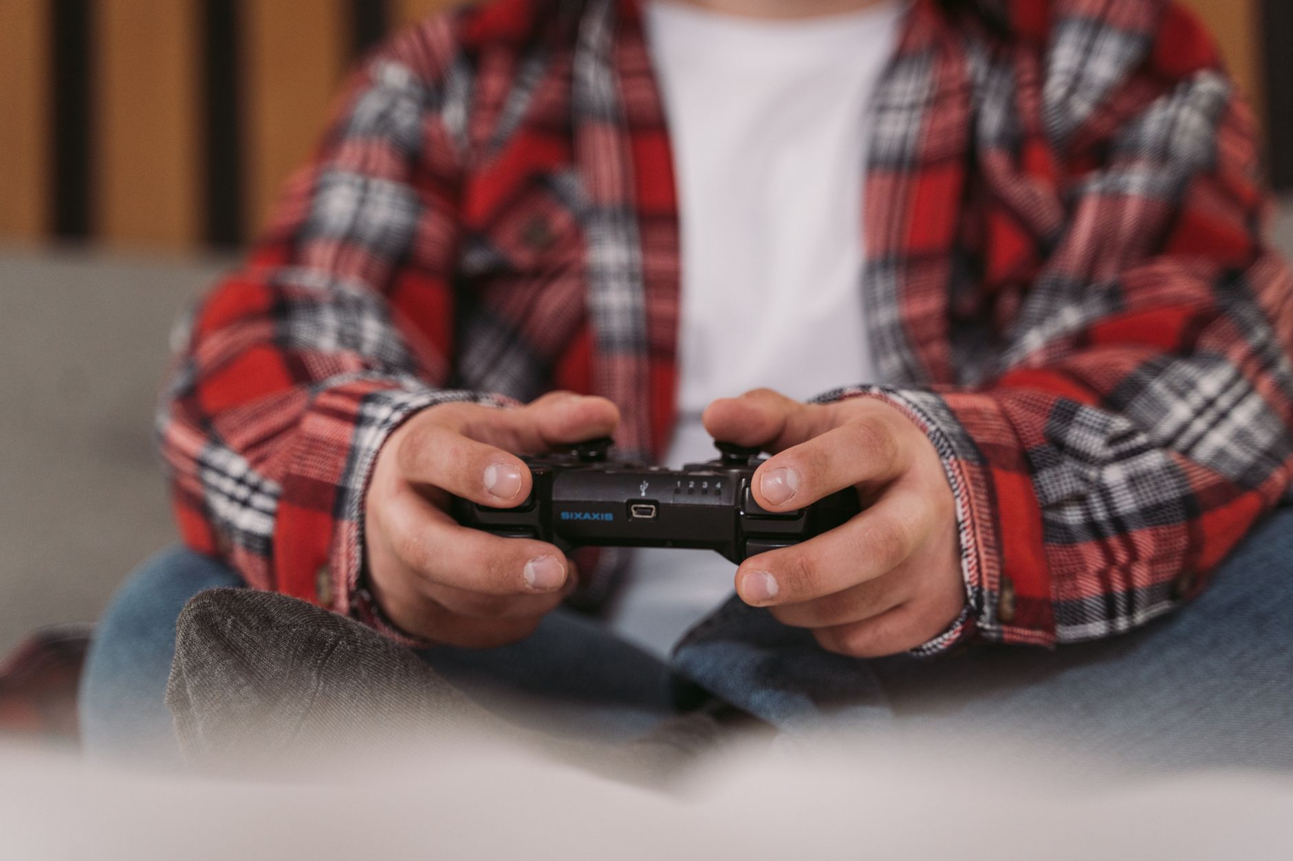 Hands holding a controller during active gameplay, illustrating muscle memory and input habits