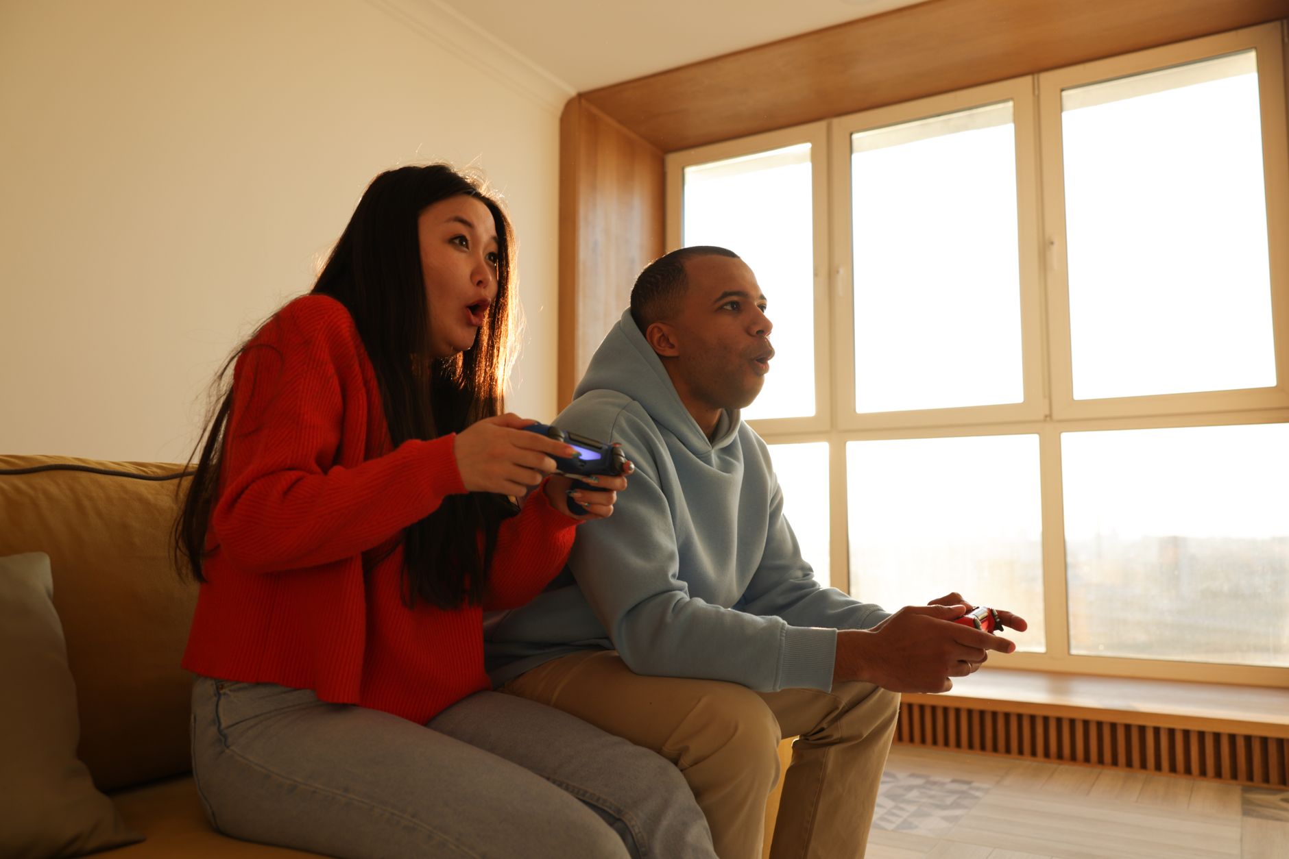 A living room with a television and gaming console setup on a media stand