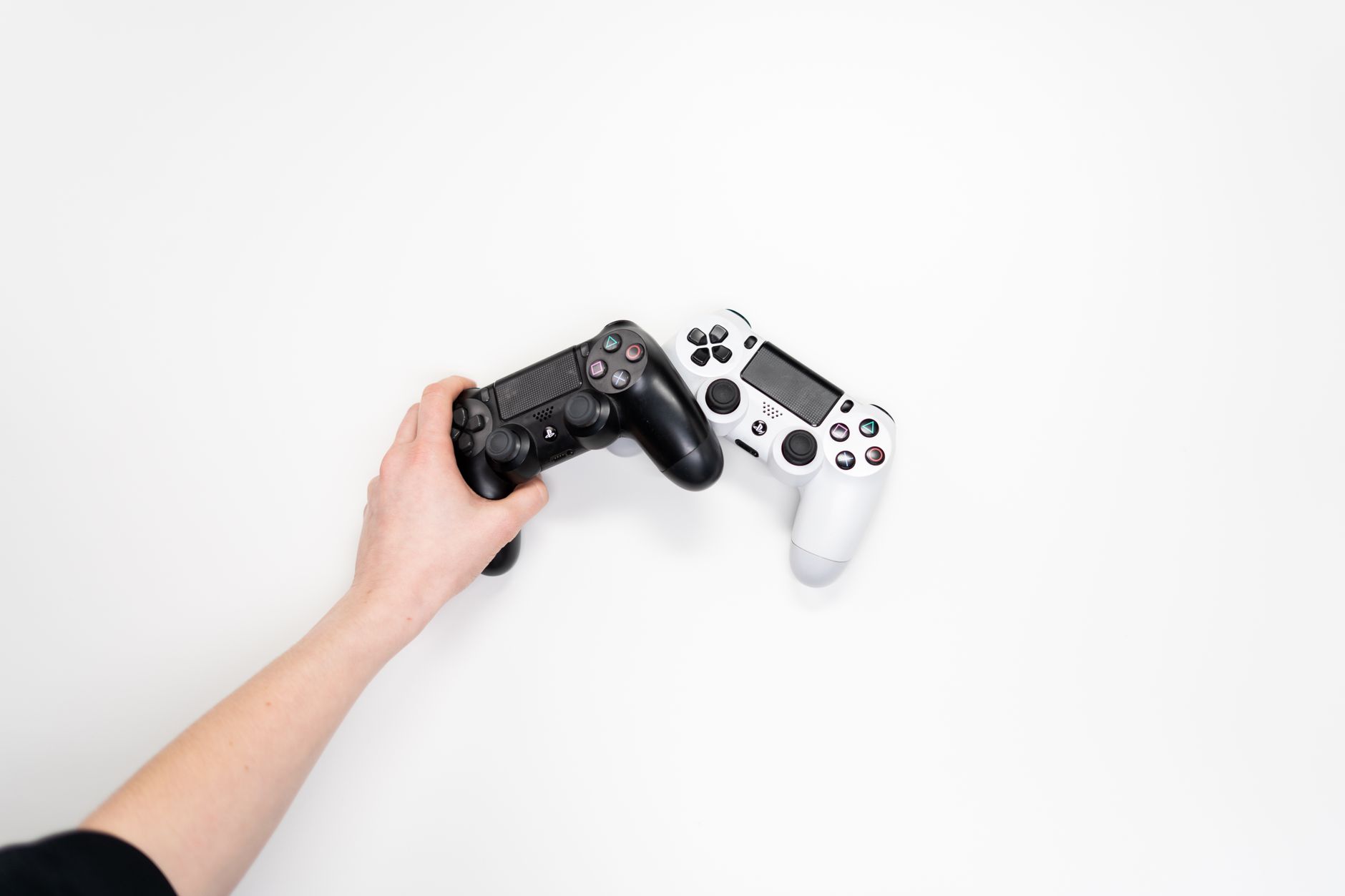 Person holding a game controller while playing, viewed from above