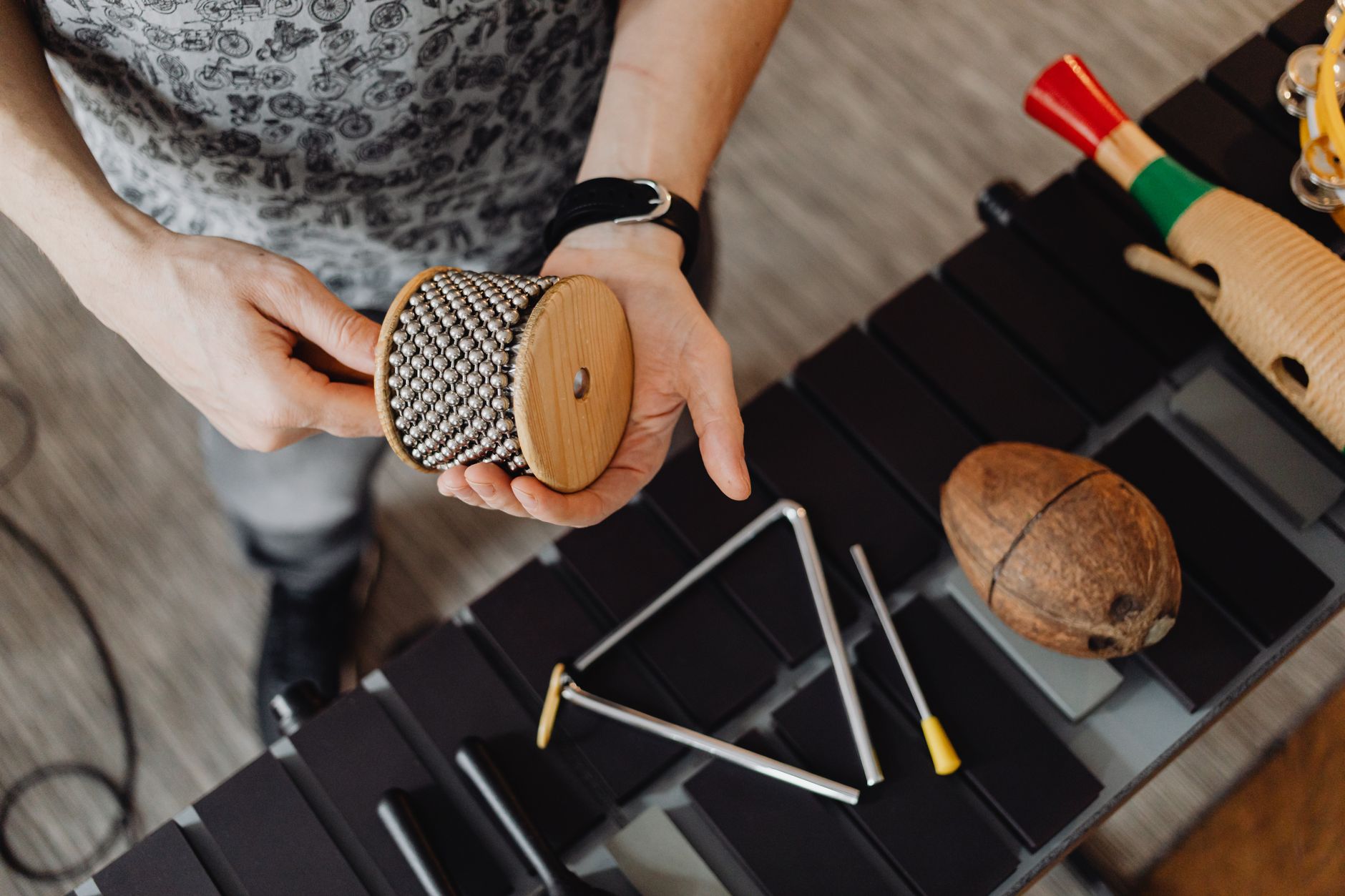 Collection of wooden percussion instruments including drums and tikis arranged on a surface