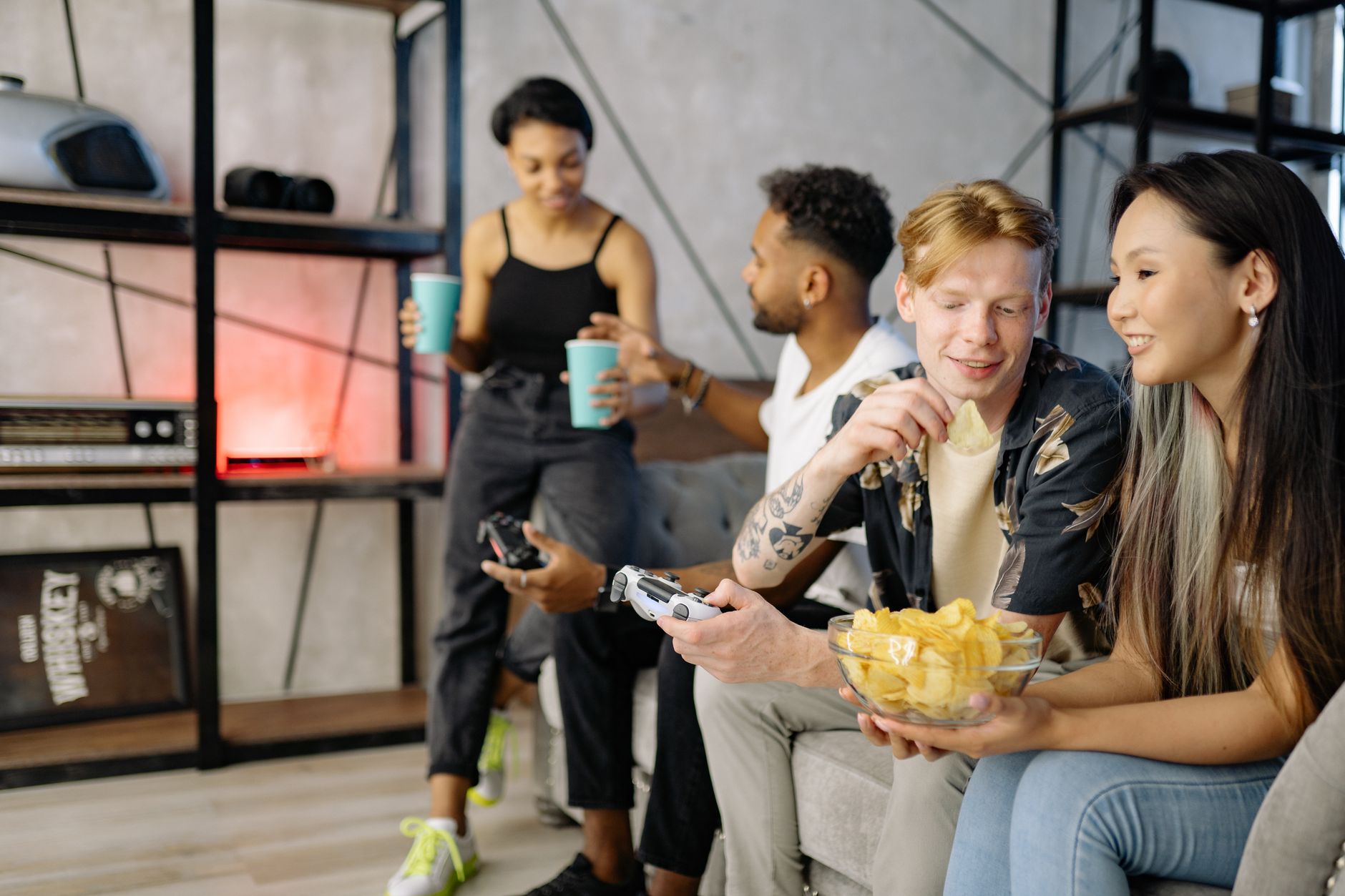 A group of people gathered around screens in a gaming community setting
