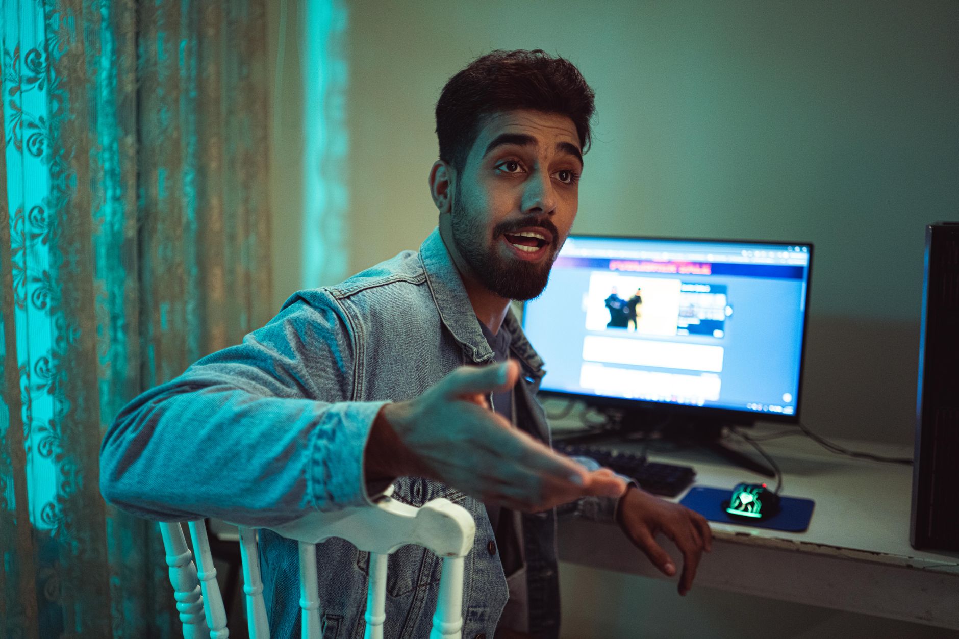 A group of people engaged in discussion around a gaming setup